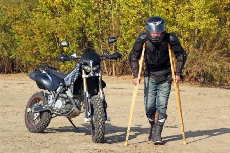 Man on crutches with a motorcycle